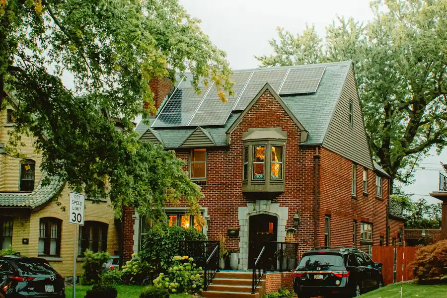 Home with solar panels on multiple roof faces for a split orientation array